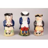 NEAR PAIR OF OLD POTTERY TOBY JUGS, modelled seated with legs crossed, together with ANOTHER,