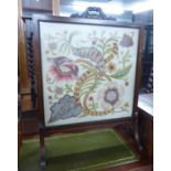 A MAHOGANY FRAMED FIRE-SCREEN, WITH FLORAL TAPESTRY INLAY