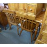 AN OBLONG PINE KITCHEN TABLE AND THREE PINE KITCHEN CHAIRS (4)