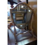 A MAHOGANY SWING TOILET MIRROR, SHIELD SHAPED, ON CHEVAL SUPPORTS