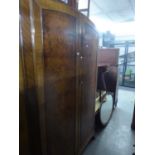 A LADY?S FIGURED WALNUT HANG WARDROBE WITH ARCHED TOP, TWO DOORS, ON OGEE BRACKET FEET