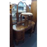 A FIGURED WALNUT WOOD ALMOST KIDNEY SHAPED DRESSING TABLE WITH TRIPLE DRESSING MIRROR, SEVEN