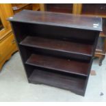 A DARK OAK THREE TIER OPEN BOOKCASE