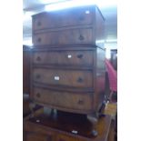 A QUARTERED MAHOGANY BOW FRONTED CHEST OF 5 DRAWERS, ON STUMP CABRIOLE SUPPORTS