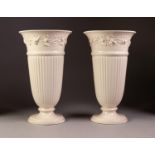 PAIR OF EARLY TWENTIETH CENTURY WEDGWOOD CREAMWARE POTTERY PEDESTAL VASES, each of fluted, footed