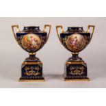 PAIR OF LATE NINETEENTH/ EARLY TWENTIETH CENTURY VIENNA PORCELAIN TWO HANDLED PEDESTAL VASES, each