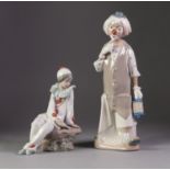 NAO PORCELAIN FIGURE OF A YOUNG PIERROT, modelled seated, reading a letter, 6 ¾? (17.2cm) high,