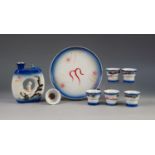 UNUSUAL POST WAR JAPANESE SEVEN PIECE PORCELAIN SAKE SET FOR SIX PERSONS, comprising: donut shaped