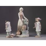 NAO PORCELAIN FIGURE OF A YOUNG GIRL WITH AN AMPHORA AT A WELL, 11 ½? (29.2cm) high, together with a