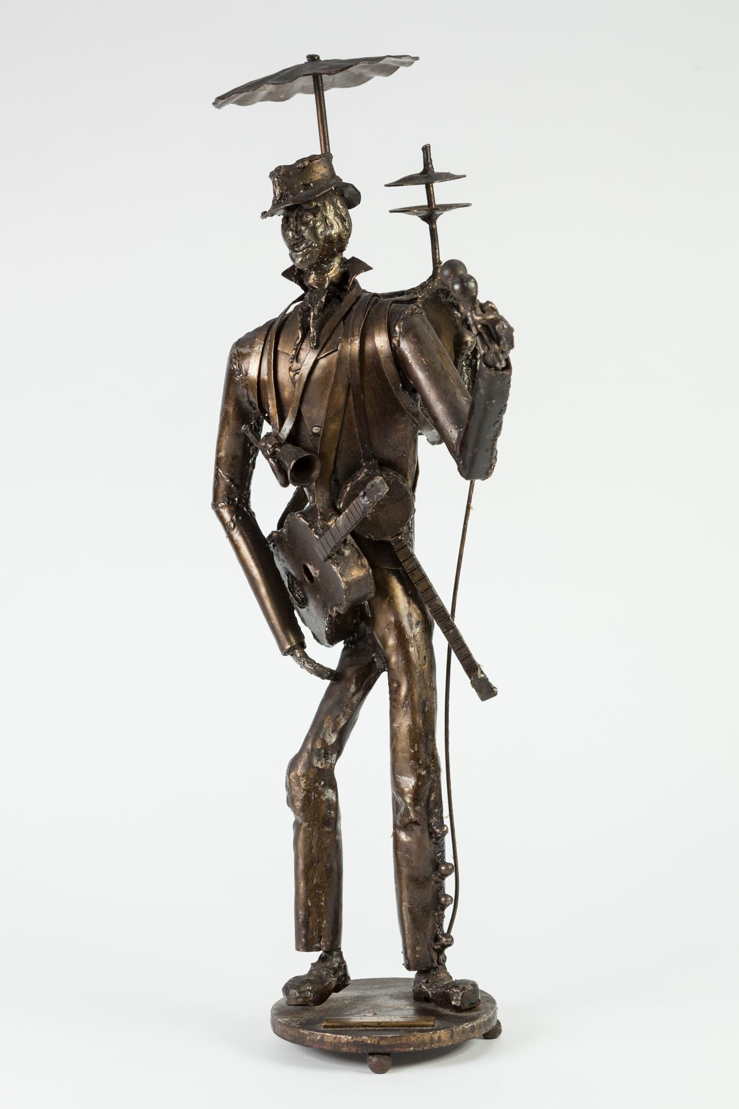 F.J. AKERS (MODERN) BRONZE PATINATED WHITE METAL SCULPTURED FIGURE Entitled 'The Maestro' applied