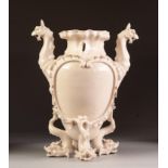 LATE NINETEENTH CENTURY CONTINENTAL CREAM GLAZED AND MOULDED TWO HANDLED VASE, the body with