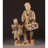 GOOD JAPANESE SECTIONAL CARVED IVORY FIGURAL GROUP of a street vendor purveying masks and dames,