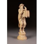 CARVED 19th CENTURY DIEPPE IVORY FIGURE of mall street entertainer encouraging caged bird to song,