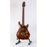CRUISER BY CRAFTER, SIX STRING ELECTRIC GUITAR, in mid brown fiddleback, with gilt and black