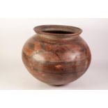 AN AGED BELIEVED TO BE PRE-COLUMBIAN EARTHENWARE CINERARY CONTAININER, with everted rim for