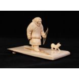 PROBABLY RUSSIAN, CARVED IVORY FIGURE OF AN ARCTIC HUNTSMAN, modelled on skis, carrying a bow, and