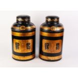 PAIR OF BLACK JAPANNED AND GILT PRINTED TIN, LARGE TEA CANISTERS AND COVERS, each of typical form,