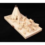 EARLY TWENTIETH CENTURY RUSSIAN CARVED IVORY GROUP, modelled as an Arctic scene with figures, tepee,