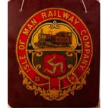 MID 20th CENTURY CHROMOLITHOGRAPHIC PRINT, COAT OF ARMS OF THE ISLE OF MAN RAILWAY Co on dark red