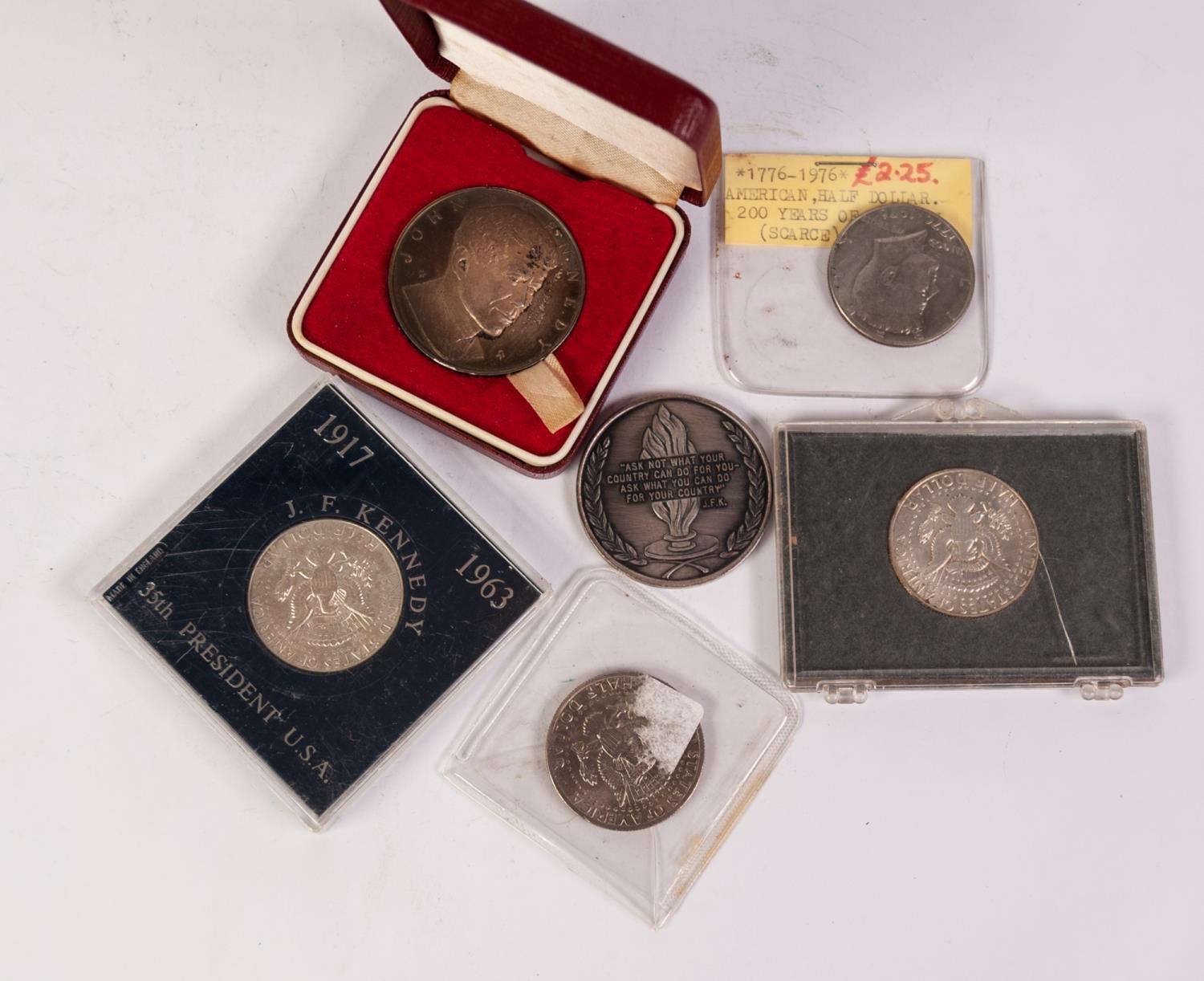 THREE AMERICAN SILVER KENNEDY HALF DOLLARS two being in hard plastic cases, one inscribed 'In
