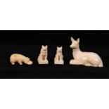 FOUR EARLY TWENTIETH CENTURY CARVED IVORY MODELS OF ANIMALS, comprising: PAIR OF SEATED HUSKY DOGS