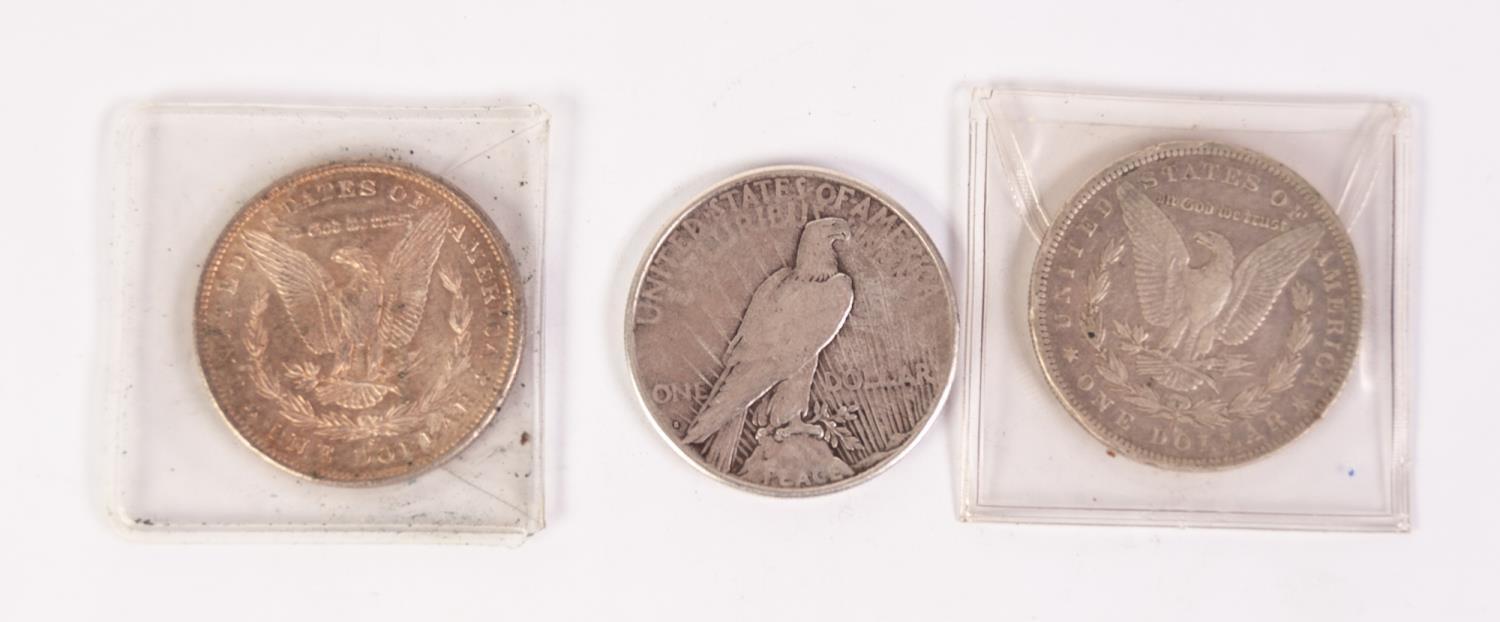 THREE AMERICAN SILVER DOLLARS, viz 1879 (VF), 1884 (F) and 1922, showing a little wear (3)