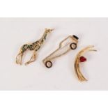 THREE MODERN GLASS SET GILT METAL BROOCHES, one as a giraffe, another of a bygone car and the