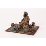 AN UNSIGNED BERGMAN COLD PAINTED BRONZE GROUP OD ARAB TEACHER WITH THREE CHILDREN all seated on