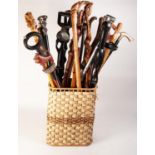 TWENTY TWO MODERN CARVED WOOD WALKING STICKS, mainly African. TOGETHER WITH TWO SHOE HORNS, two