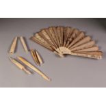 LATE 18th CENTURY EUROPEAN CARVED AND PIERCED IVORY BRISE FAN later applied with paper leaf sequin ,