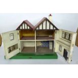 AMERSHAM DOLLS HOUSE with garage an a labelled green plinth base 26" (66) x 12" (30.5)