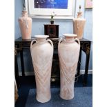 PAIR OF MODERN TERRACOTTA EFFECT POTTERY LARGE TWO HANDLED URN PATTERN FLOOR VASES, of slightly