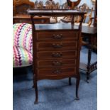 EDWARDIAN INLAID AND SERPENTINE FRONTED MAHOGANY SHEET MUSIC CABINET IN THE ARTS AND CRAFTS STYLE,