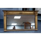 EARLY NINETEENTH CENTURY GILT WOOD AND GESSO OVERMANTLE MIRROR, the oblong plate with reeded,