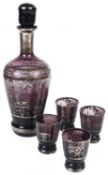 A Bohemian purple and silvered glass liqueur decanter with four matching shot glasses