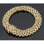 A 9ct gold articulated bracelet of bar link design