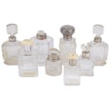 A collection of Edwardian and later glass and silver perfume/cologne bottles