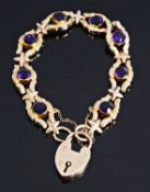 An Edwardian hollow rose gold and amethyst set scroll bracelet