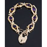 An Edwardian hollow rose gold and amethyst set scroll bracelet