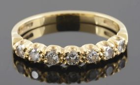 A delicate diamond set half eternity ring together with a sapphire and diamond set cluster ring