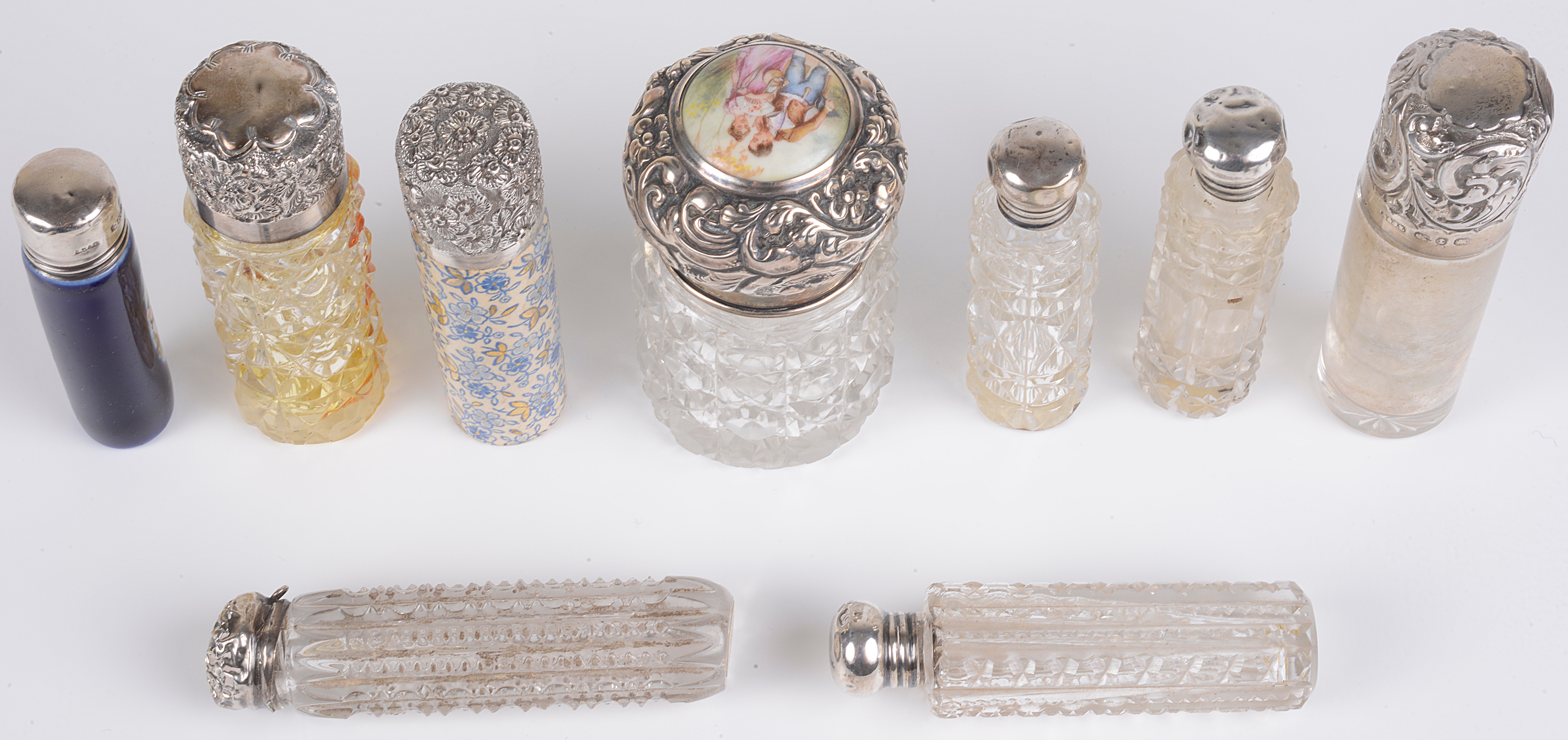 A collection of Victorian glass and silver topped cylindrical bottles