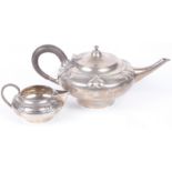 A delightful Edwardian silver Arts and Craft teapot and matching milk jug, hallmarked Birm. 1904