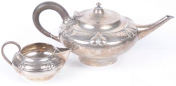 A delightful Edwardian silver Arts and Craft teapot and matching milk jug, hallmarked Birm. 1904