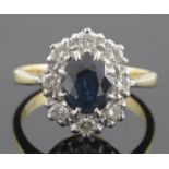 A sapphire and diamond set oval cluster ring