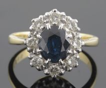 A sapphire and diamond set oval cluster ring