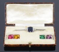 An unusual Art Deco silver and interchangeable coloured paste 'gem' brooch in original fitted case,