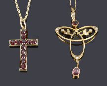 An Art Nouveau garnet and seed pearl scroll pendant and a Victorian garnet set cross