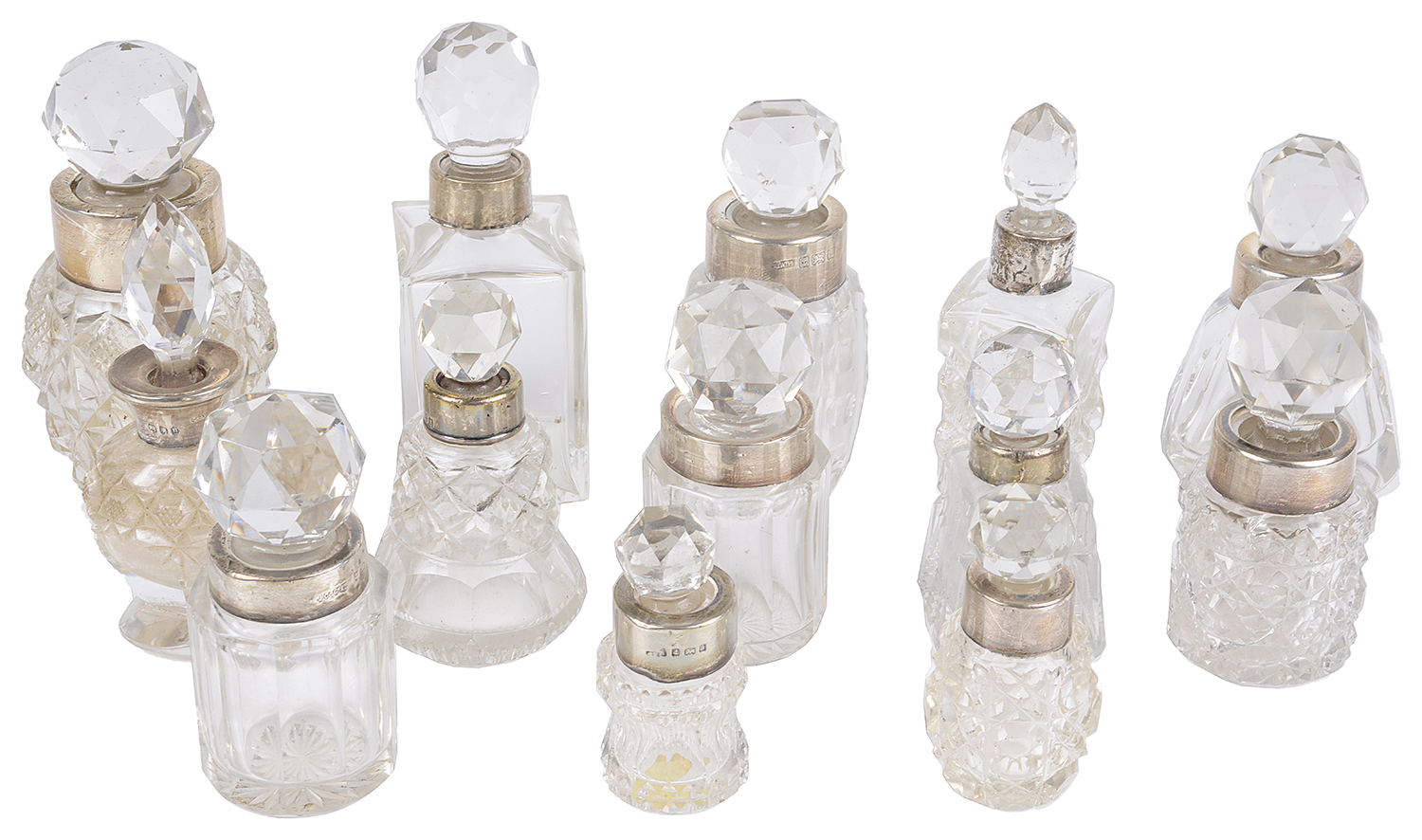 A collection of small glass and silver scent bottles