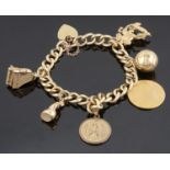 A yellow metal curb link charm bracelet