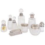 An assorted collection of silver and glass perfume bottles